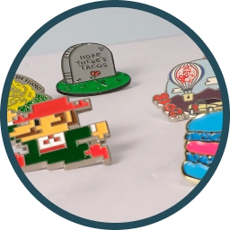Custom enamel pins including pixel-style and illustrated designs